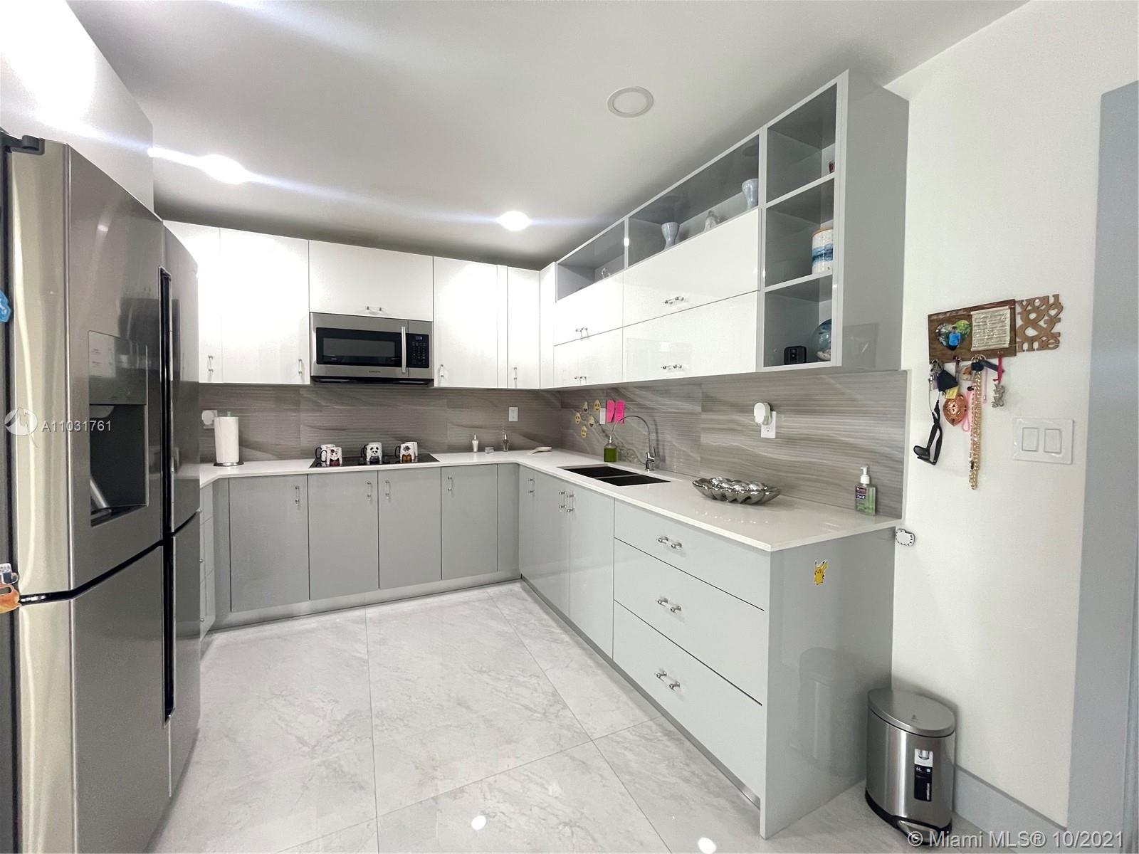 3541 Southwest 105th Court Miami, FL 33165 - Photo 14 of 45 a kitchen with kitchen island a sink stainless steel appliances and cabinets