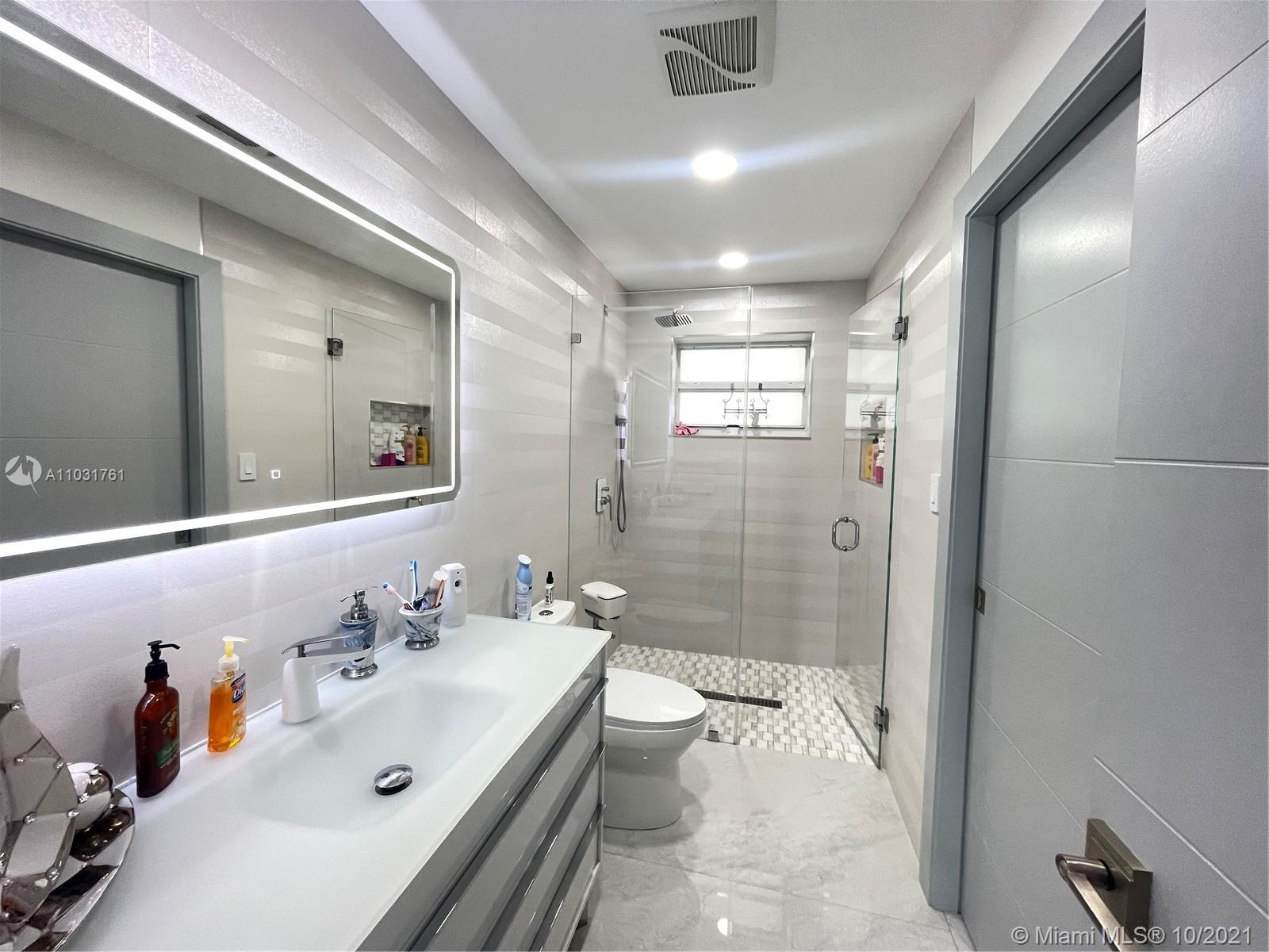 3541 Southwest 105th Court Miami, FL 33165 - Photo 16 of 45 a bathroom with a sink double vanity and a shower