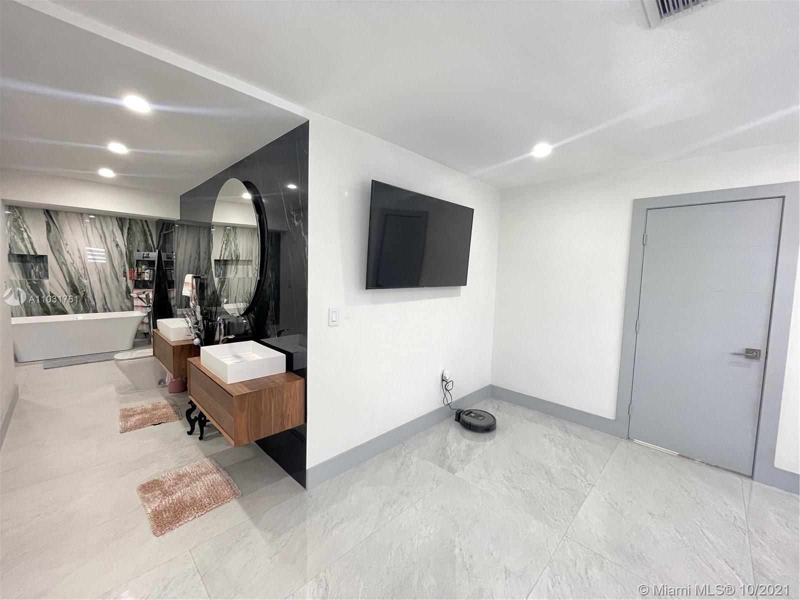 3541 Southwest 105th Court Miami, FL 33165 - Photo 23 of 45 a view of a livingroom with furniture and a flat screen tv