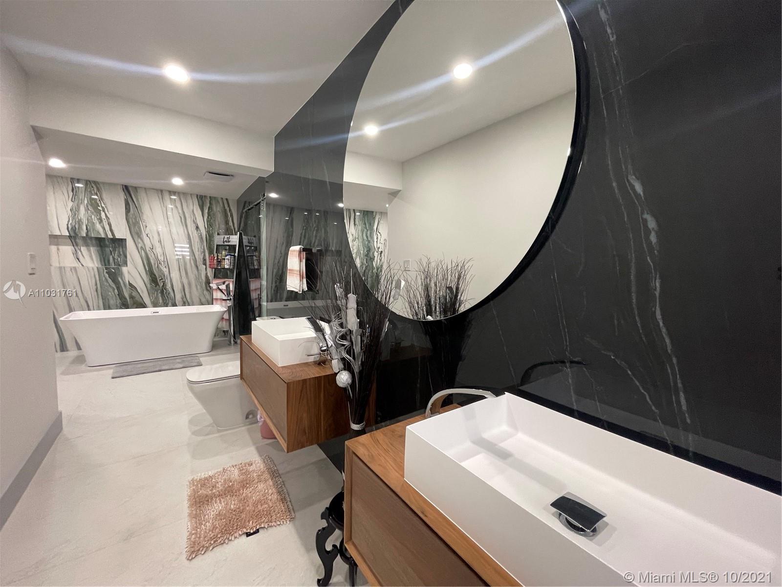 3541 Southwest 105th Court Miami, FL 33165 - Photo 24 of 45 a bathroom with a sink a toilet and a mirror