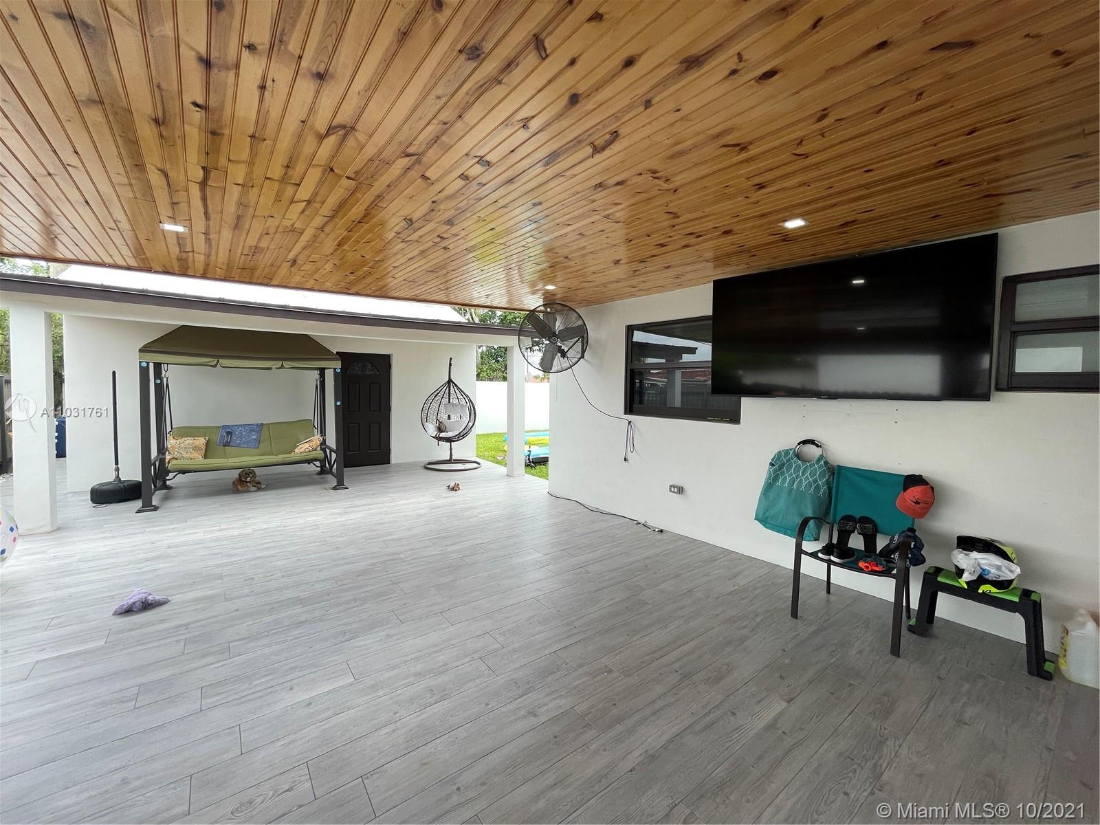 3541 Southwest 105th Court Miami, FL 33165 - Photo 35 of 45 a living room with furniture flat screen tv and refrigerator