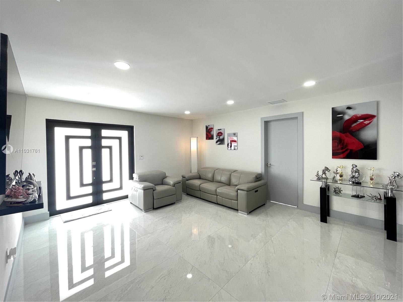 3541 Southwest 105th Court Miami, FL 33165 - Photo 7 of 45 a living room with furniture and paintings on the wall