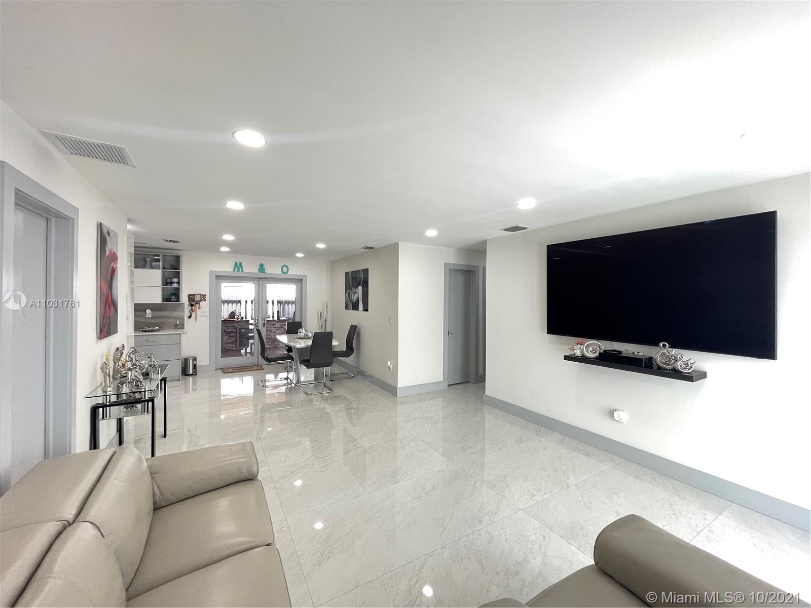 3541 Southwest 105th Court Miami, FL 33165 - Photo 8 of 45 a living room with furniture and a flat screen tv