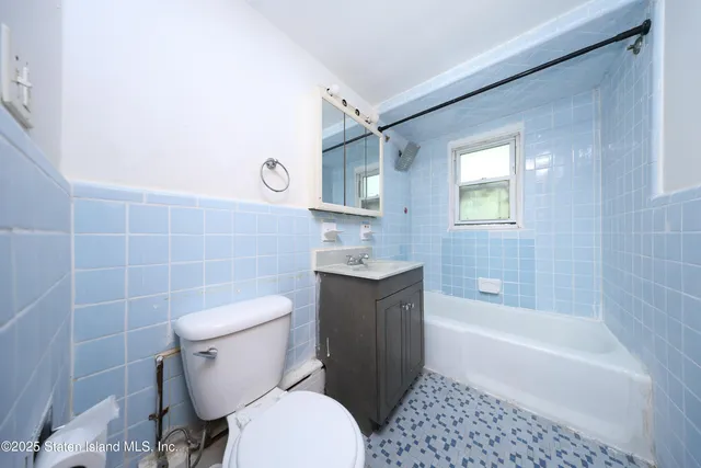 a bathroom with a toilet a sink and bathtub