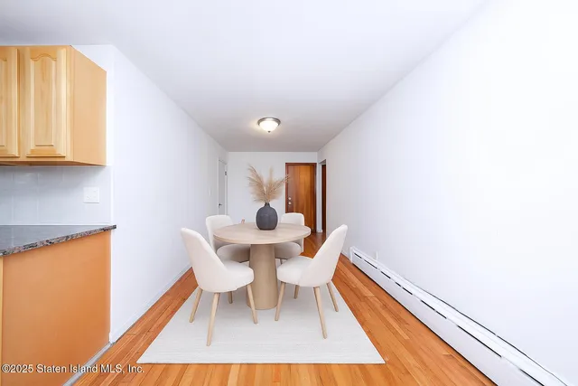 a dining room with furniture and wooden floor