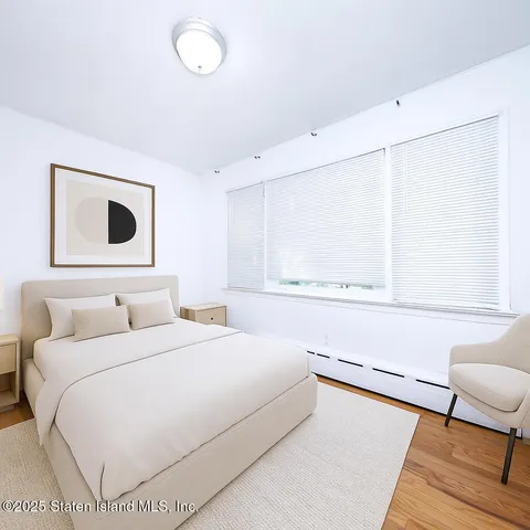 a bedroom with a large bed and a window