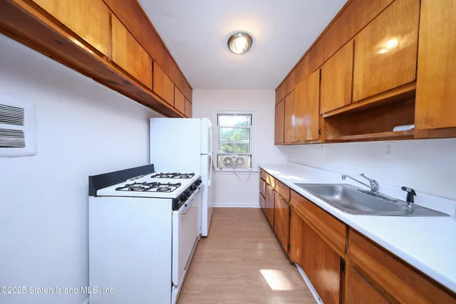 a kitchen with stainless steel appliances granite countertop a stove and a sink