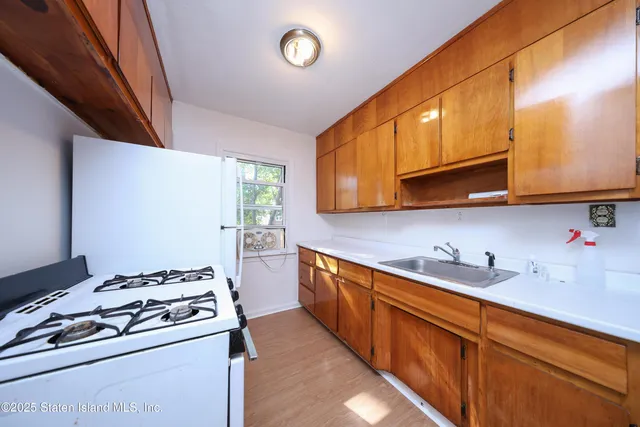 a kitchen with stainless steel appliances granite countertop a sink stove and cabinets
