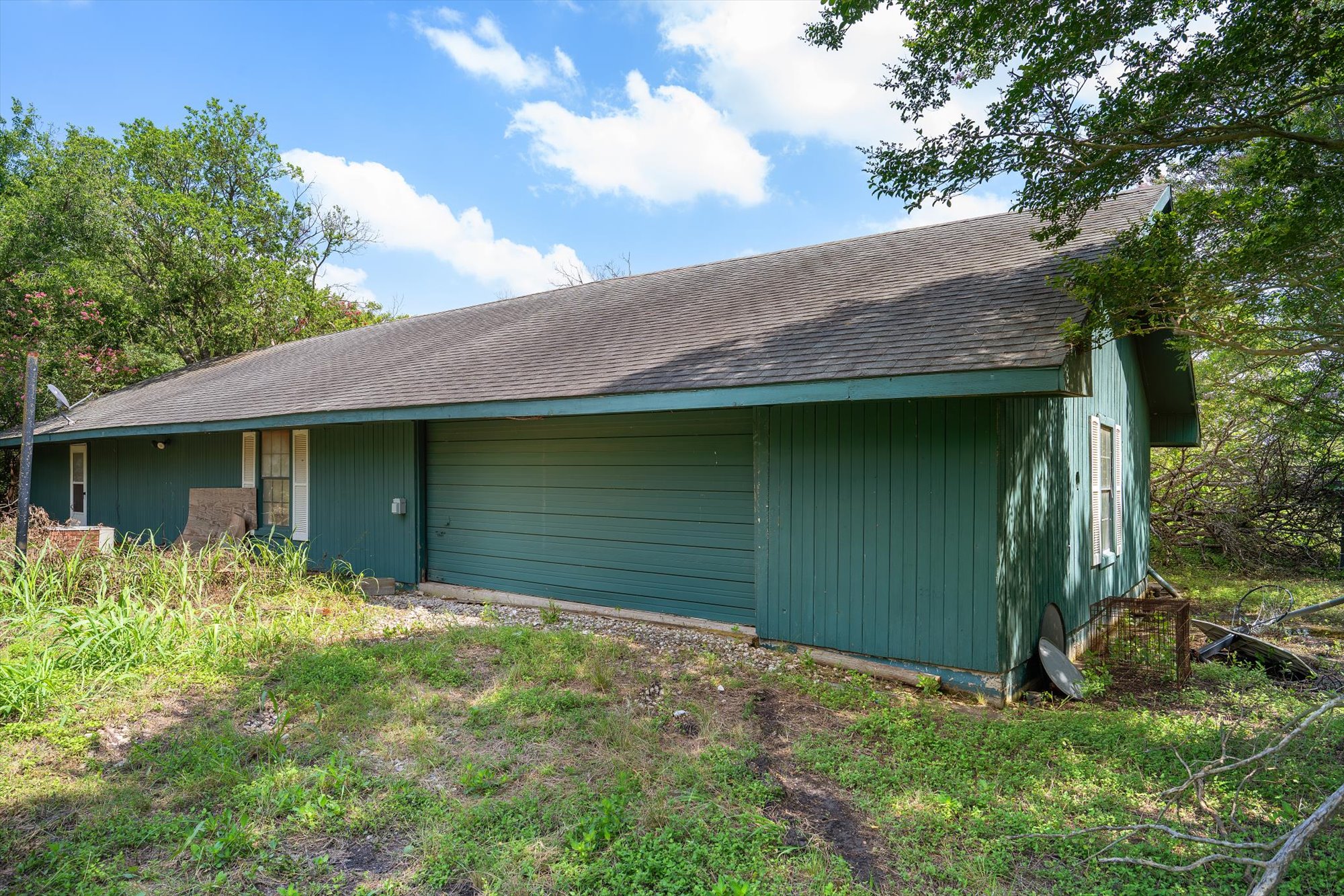 14201 Lund - Carlson Road Coupland, TX 78615 - Photo 38 of 40 A classic residential structure with an attached garage, offering practical living space.