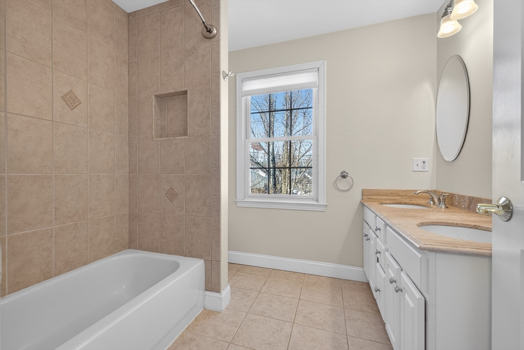 36 Prospect Street, Unit 1 Waltham, MA 02453 - Photo 11 of 16 a bathroom with a tub sink and mirror
