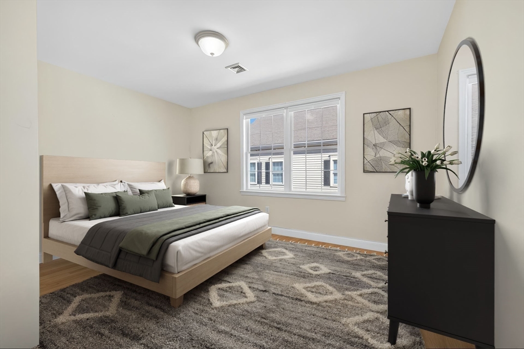 36 Prospect Street, Unit 1 Waltham, MA 02453 - Photo 12 of 16 a bedroom with bed and window