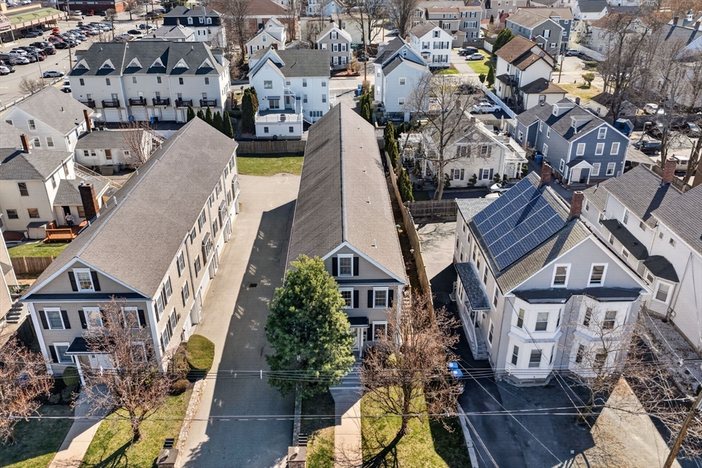 36 Prospect Street, Unit 1 Waltham, MA 02453 - Photo 16 of 16 an aerial view of a residential apartment building with a yard