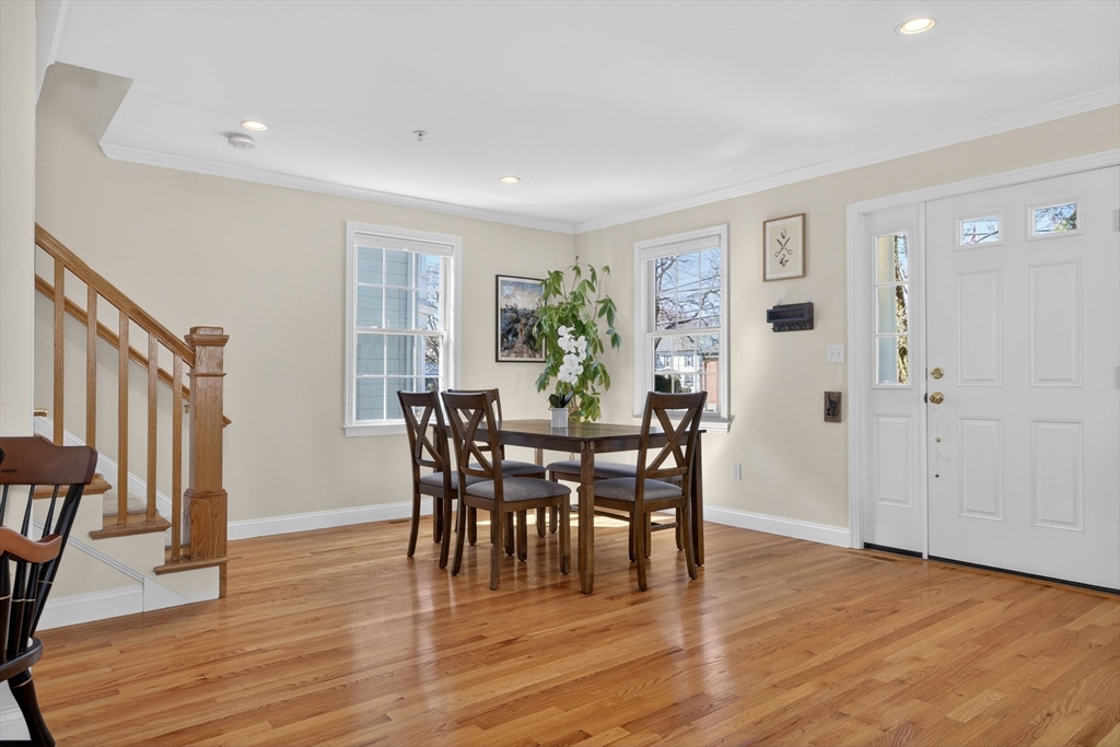 36 Prospect Street, Unit 1 Waltham, MA 02453 - Photo 3 of 16 a view of a dining room with furniture and wooden floor