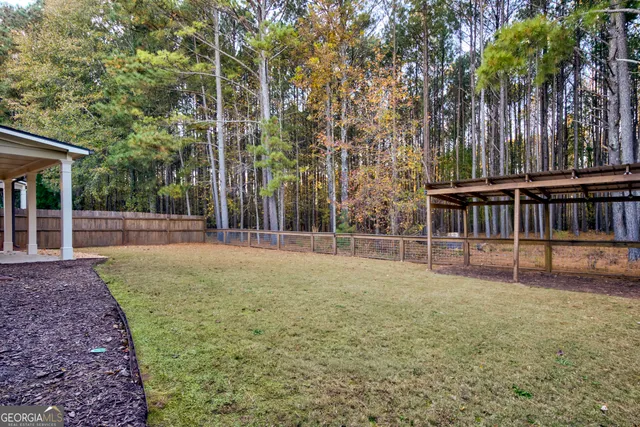 a kitchen with stainless steel appliances granite countertop a sink stove refrigerator and cabinets