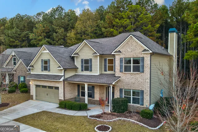 an aerial view of a house with swimming pool and patio
