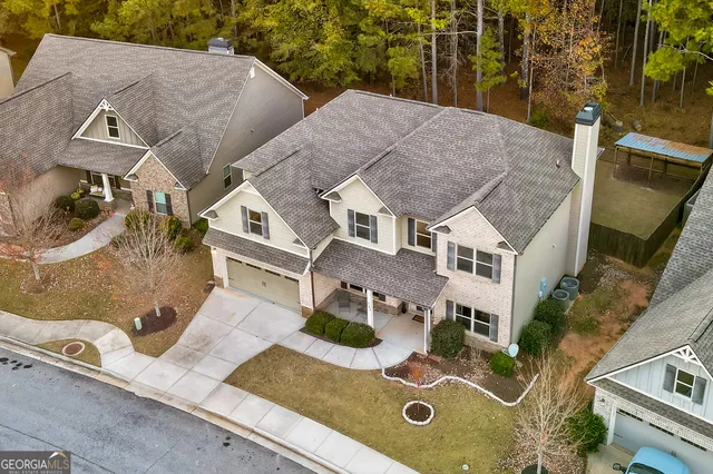 a front view of a house with a yard and trees