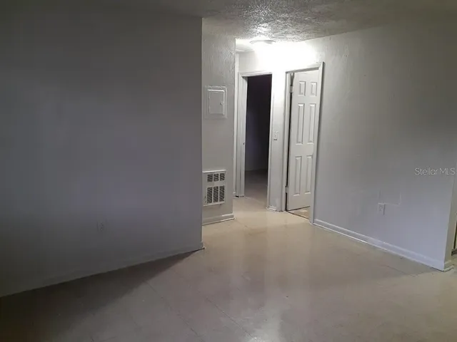 an empty room with closet and mirror