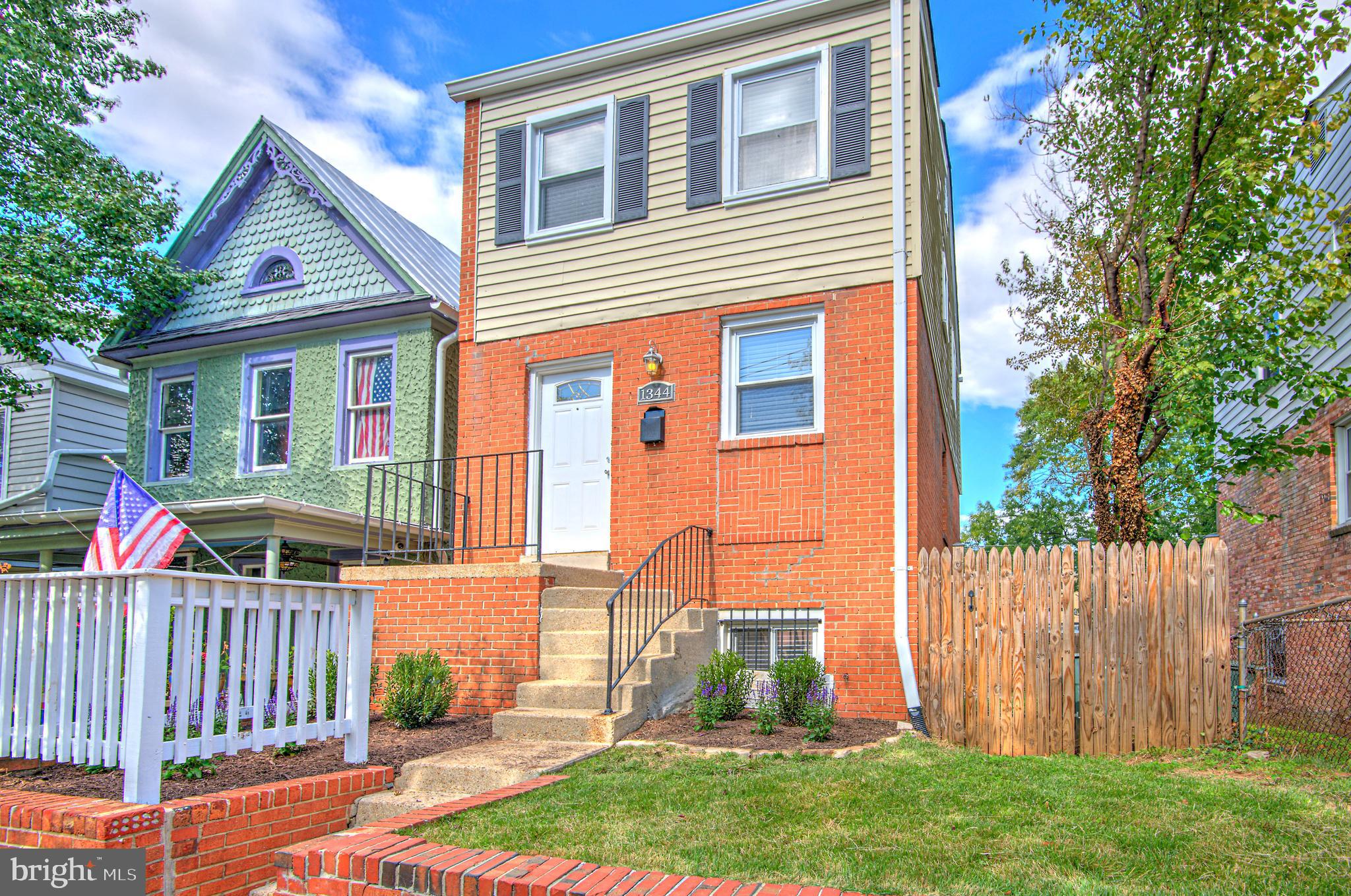 1344 Valley Place Southeast Washington, DC 20020 - Photo 1 of 27 a view of a house with a yard and wooden fence