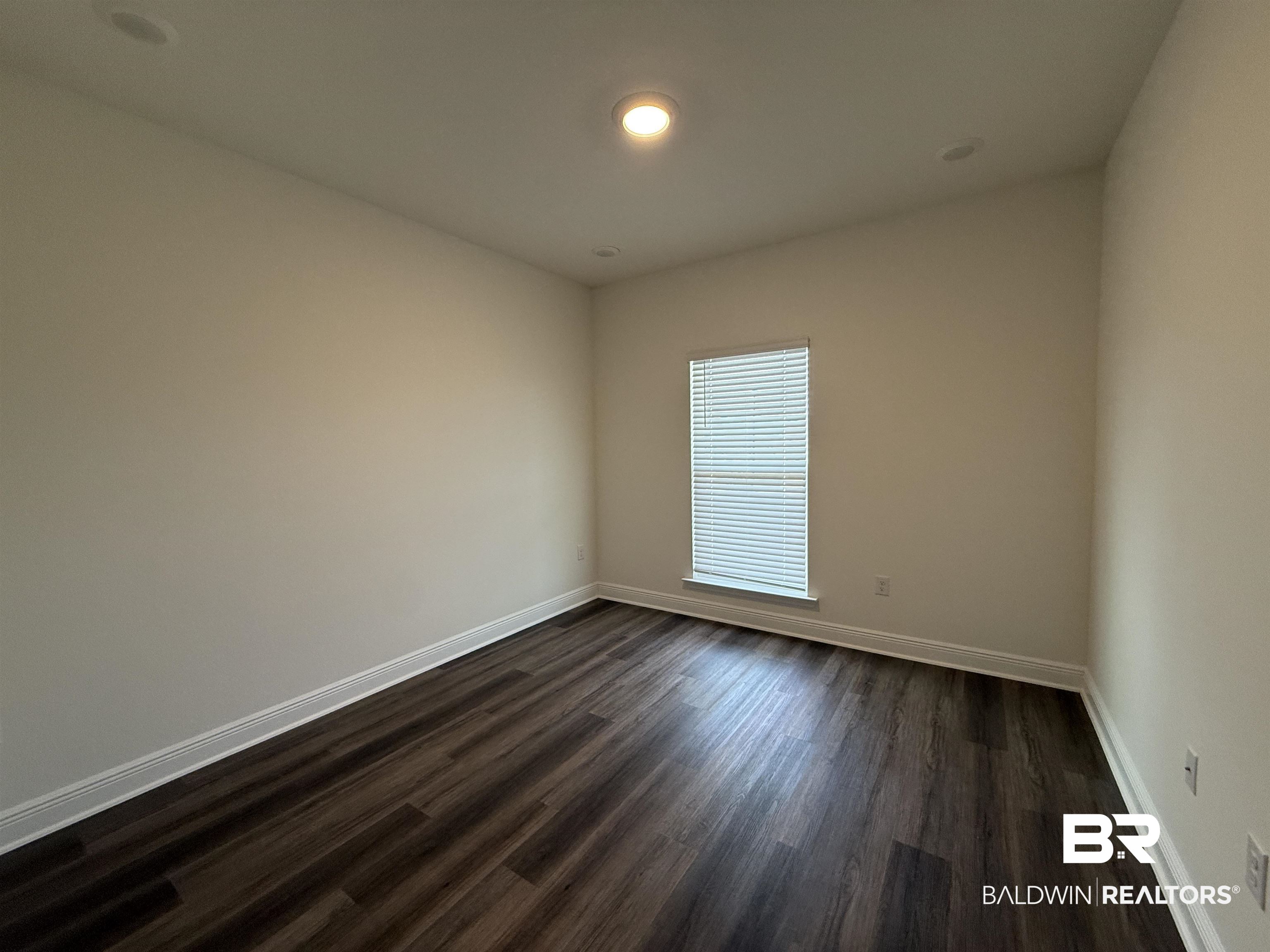 11442 Genuine Risk Circle Daphne, AL 36526 - Photo 15 of 21 Empty room with dark wood-style floors and recessed lighting