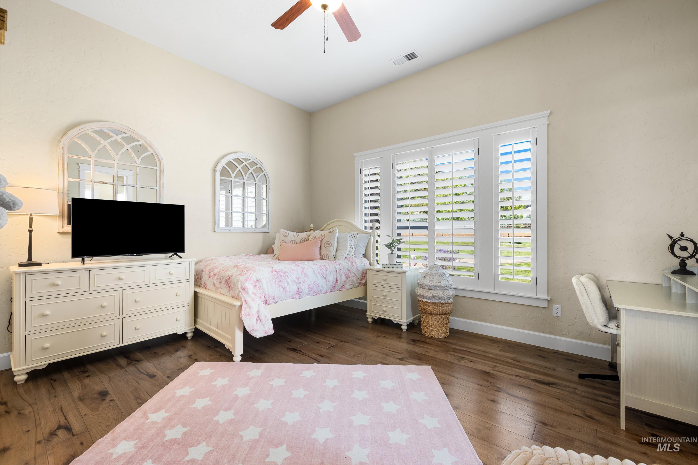 9819 Foothill Road Middleton, ID 83644 - Photo 28 of 49 Bedroom with dark wood-style flooring and a ceiling fan