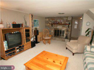 200 Preston Road Flourtown, PA 19031 - Photo 4 of 6 a living room with furniture a flat screen tv and a fireplace