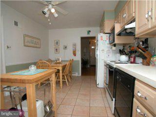 200 Preston Road Flourtown, PA 19031 - Photo 6 of 6 a kitchen with stainless steel appliances kitchen island granite countertop a table chairs and a refrigerator