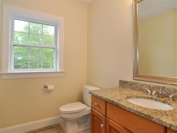14 Hatch Road Wrentham, MA 02093 - Photo 17 of 28 a bathroom with a granite countertop toilet a sink and a window