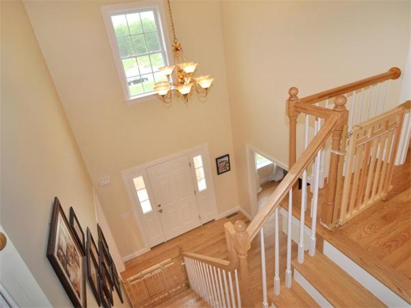 14 Hatch Road Wrentham, MA 02093 - Photo 18 of 28 a view of a livingroom with wooden floor and stairs