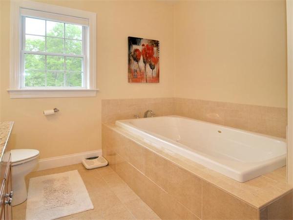 14 Hatch Road Wrentham, MA 02093 - Photo 27 of 28 a white bath tub sitting next to a toilet