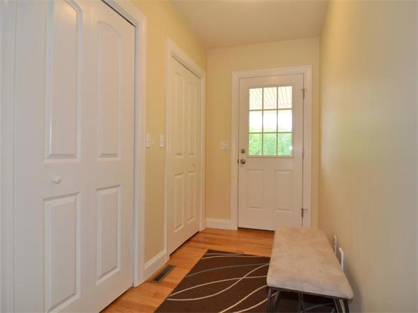 14 Hatch Road Wrentham, MA 02093 - Photo 4 of 28 a view of an empty room with wooden floor and a window