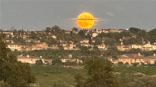 a kitchen with granite countertop a sink a stove and cabinets