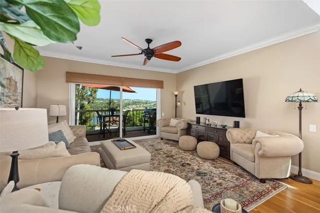 a living room with furniture a flat screen tv and a large window