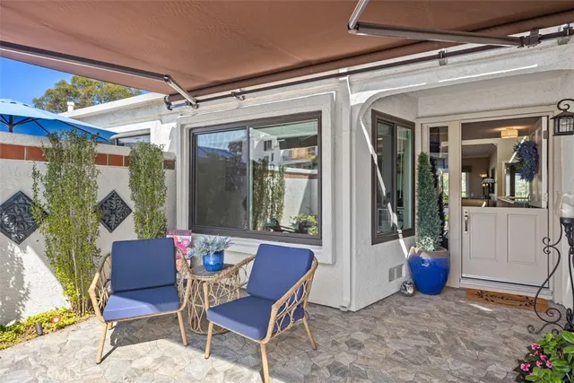 a view of a porch with a table and chairs