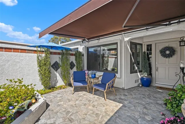 a view of a hallway with furniture and entryway