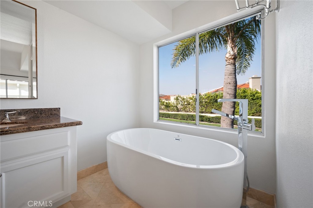 17 St John Dana Point, CA 92629 - Photo 15 of 30 a white bath tub sitting in a bathroom next to a window
