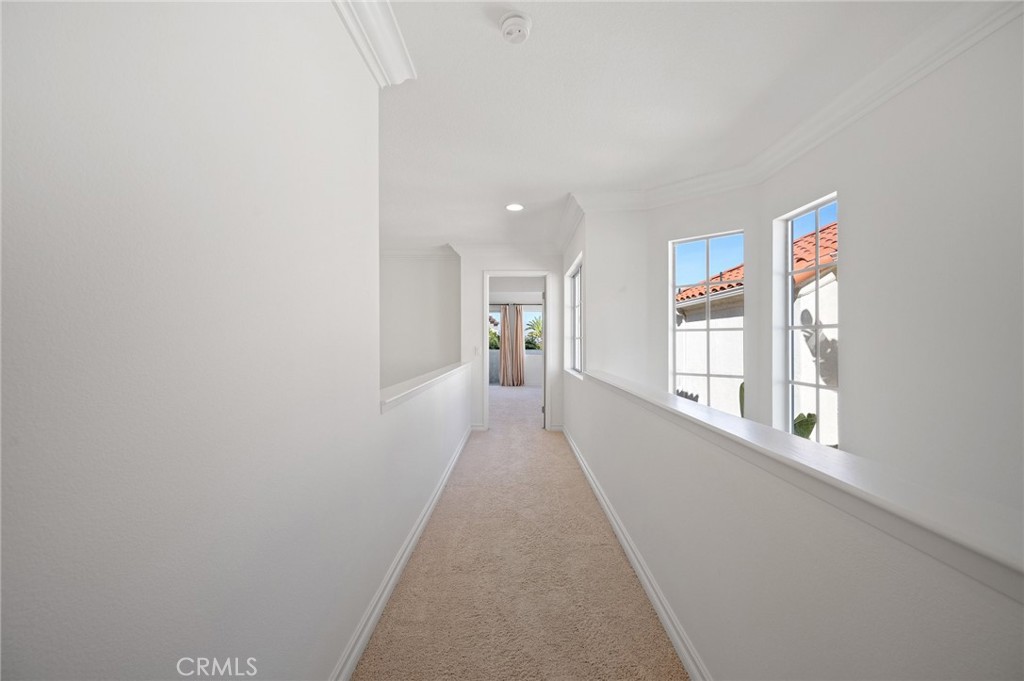 17 St John Dana Point, CA 92629 - Photo 22 of 30 a view of a hallway with wooden floor and a living room