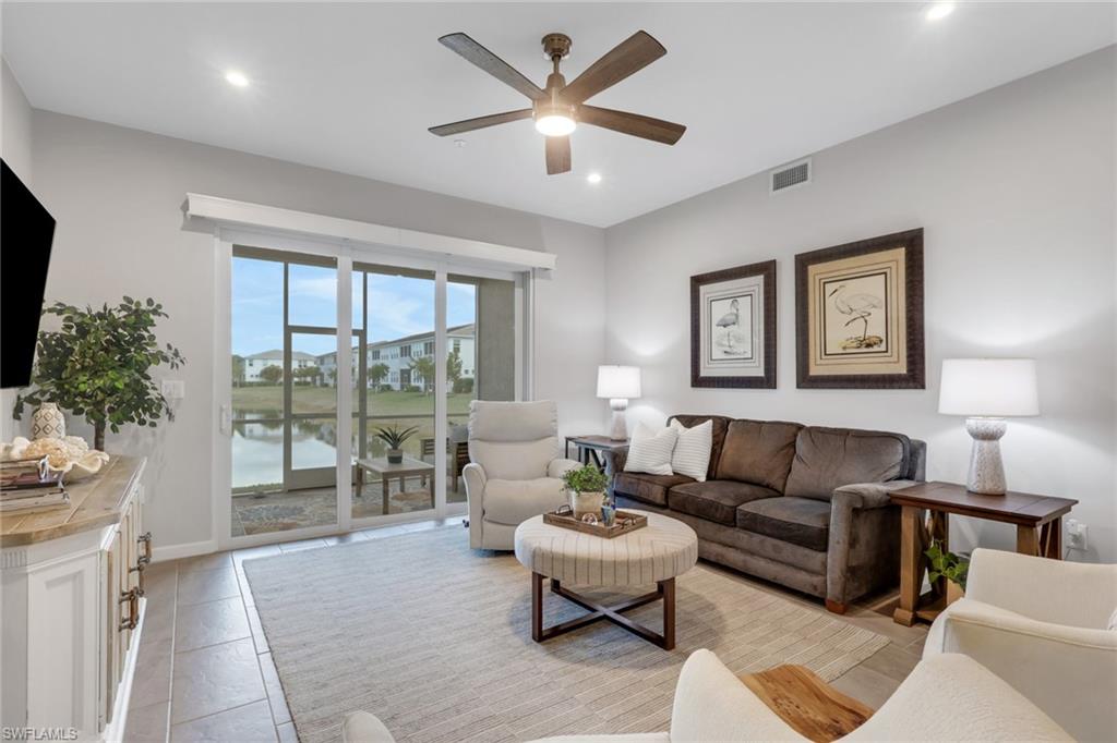 4687 Arboretum Circle, Unit 101 Naples, FL 34112 - Photo 12 of 30 a living room with furniture and a large window