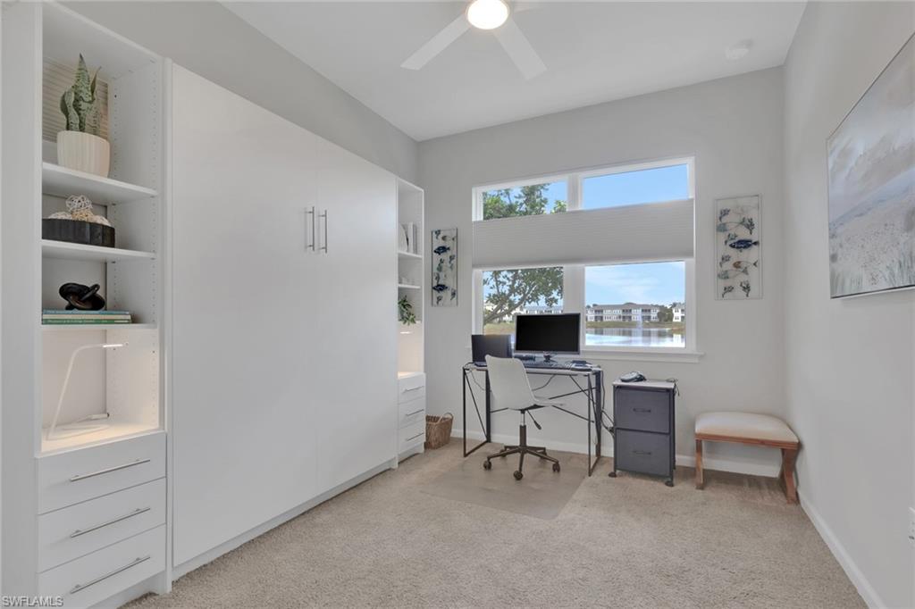 4687 Arboretum Circle, Unit 101 Naples, FL 34112 - Photo 13 of 30 a view of a workspace with furniture and a window