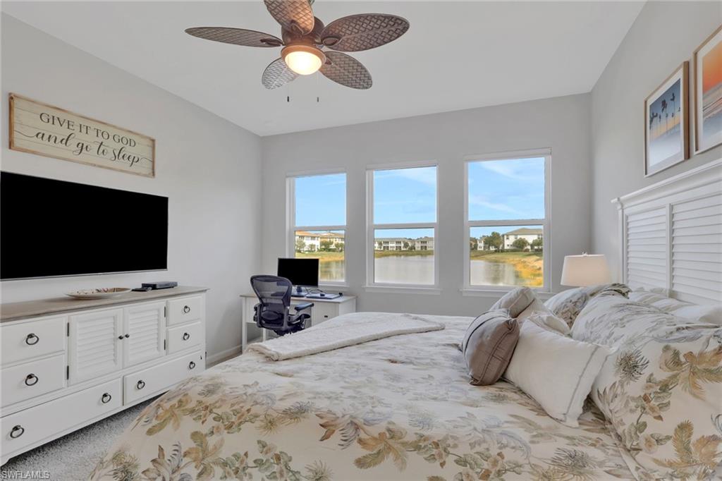 4687 Arboretum Circle, Unit 101 Naples, FL 34112 - Photo 16 of 30 a bedroom with bed tv and window
