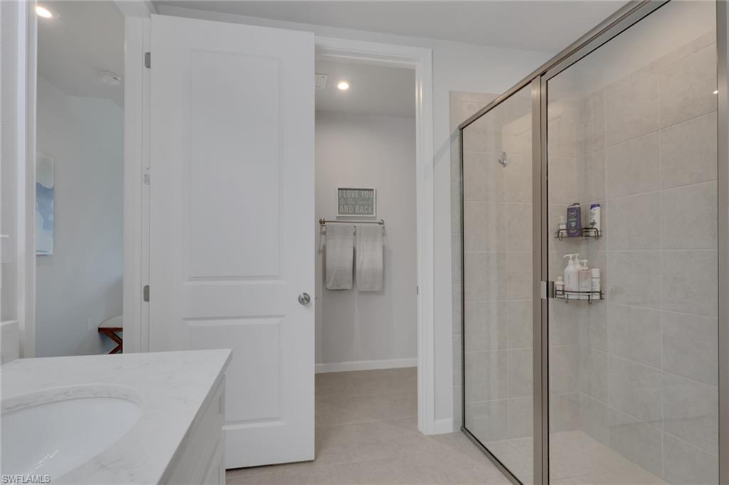 4687 Arboretum Circle, Unit 101 Naples, FL 34112 - Photo 19 of 30 a bathroom with a bathtub and a shower