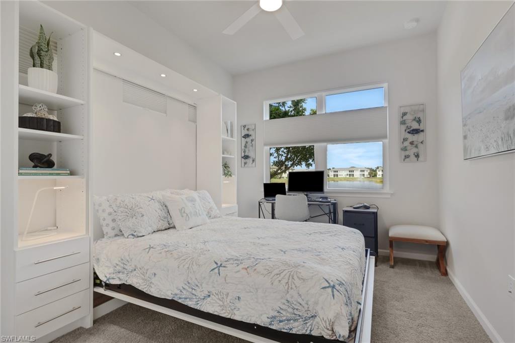 4687 Arboretum Circle, Unit 101 Naples, FL 34112 - Photo 20 of 30 a bedroom with a bed and a cabinets