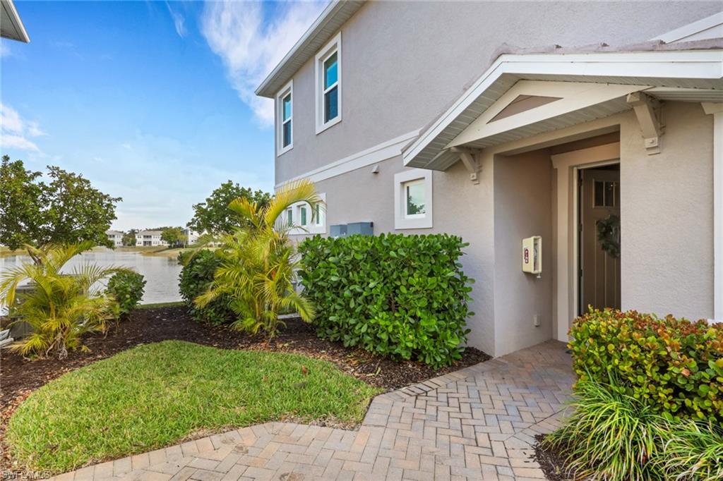 4687 Arboretum Circle, Unit 101 Naples, FL 34112 - Photo 2 of 30 a front view of a house with garden