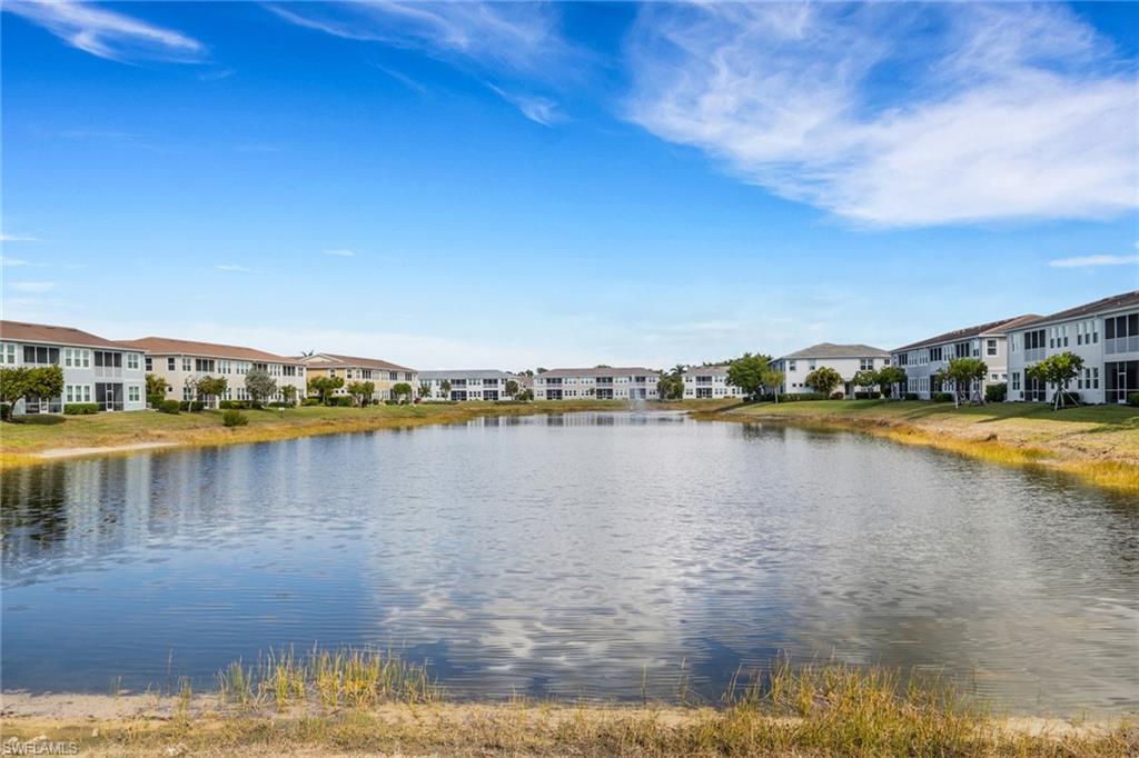 4687 Arboretum Circle, Unit 101 Naples, FL 34112 - Photo 22 of 30 a view of a lake with houses