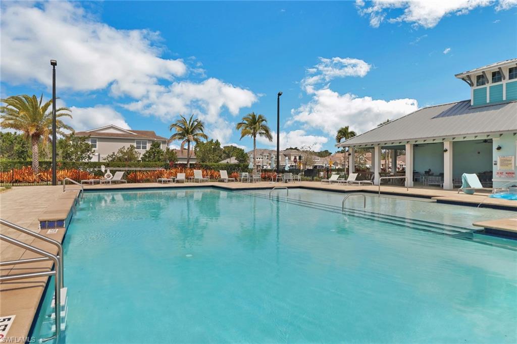 4687 Arboretum Circle, Unit 101 Naples, FL 34112 - Photo 27 of 30 a view of swimming pool with outdoor seating and city view