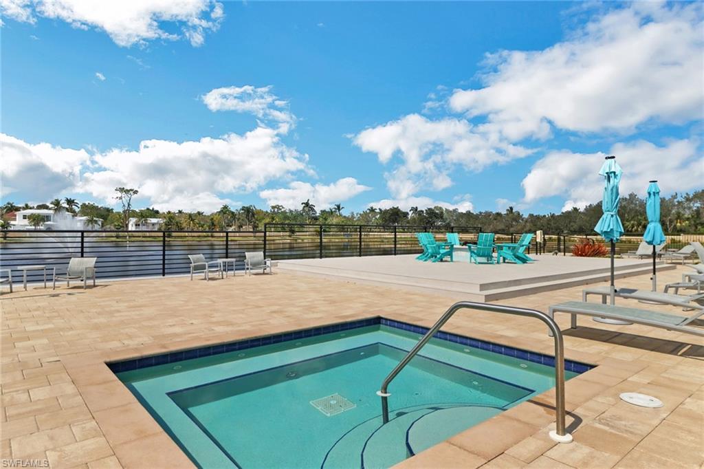 4687 Arboretum Circle, Unit 101 Naples, FL 34112 - Photo 29 of 30 a view of swimming pool with outdoor seating and yard in the back