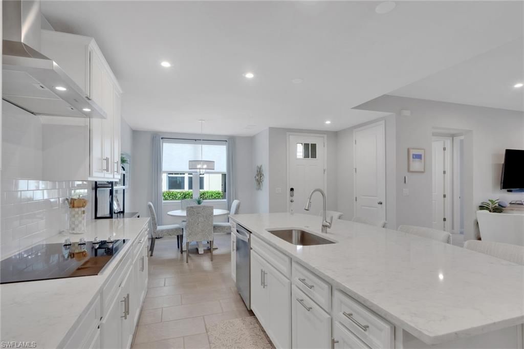 4687 Arboretum Circle, Unit 101 Naples, FL 34112 - Photo 8 of 30 a large white kitchen with a large window