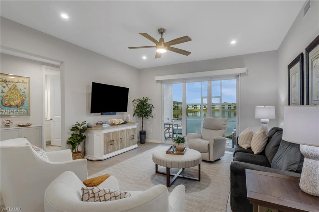 4687 Arboretum Circle, Unit 101 Naples, FL 34112 - Photo 9 of 30 a living room with furniture and a flat screen tv