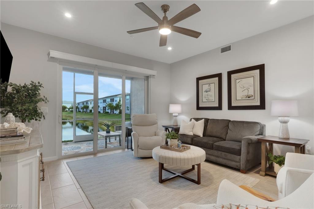 4687 Arboretum Circle, Unit 101 Naples, FL 34112 - Photo 10 of 30 a living room with furniture and a large window