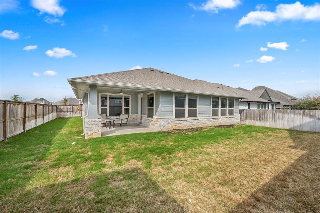 1012 Quarry Point Pass Leander, TX 78641 - Photo 30 of 39 A spacious private yard with a covered patio for outdoor enjoyment.