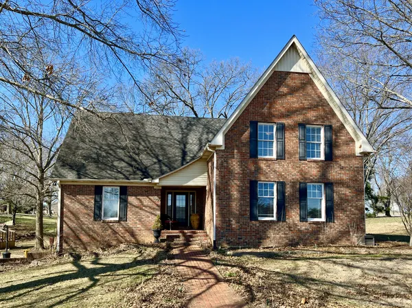 a front view of a house with yard
